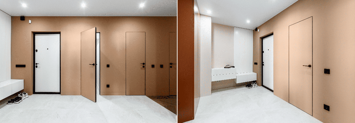 Входные металлические двери с черной рамой в светлом коридоре с минималистичным дизайном.