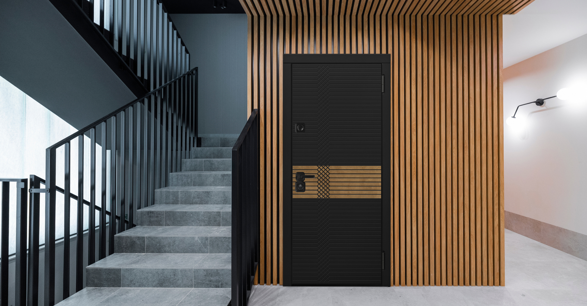 Входная дверь в квартиру с чёрным полотном и деревянной вставкой в современном интерьере.